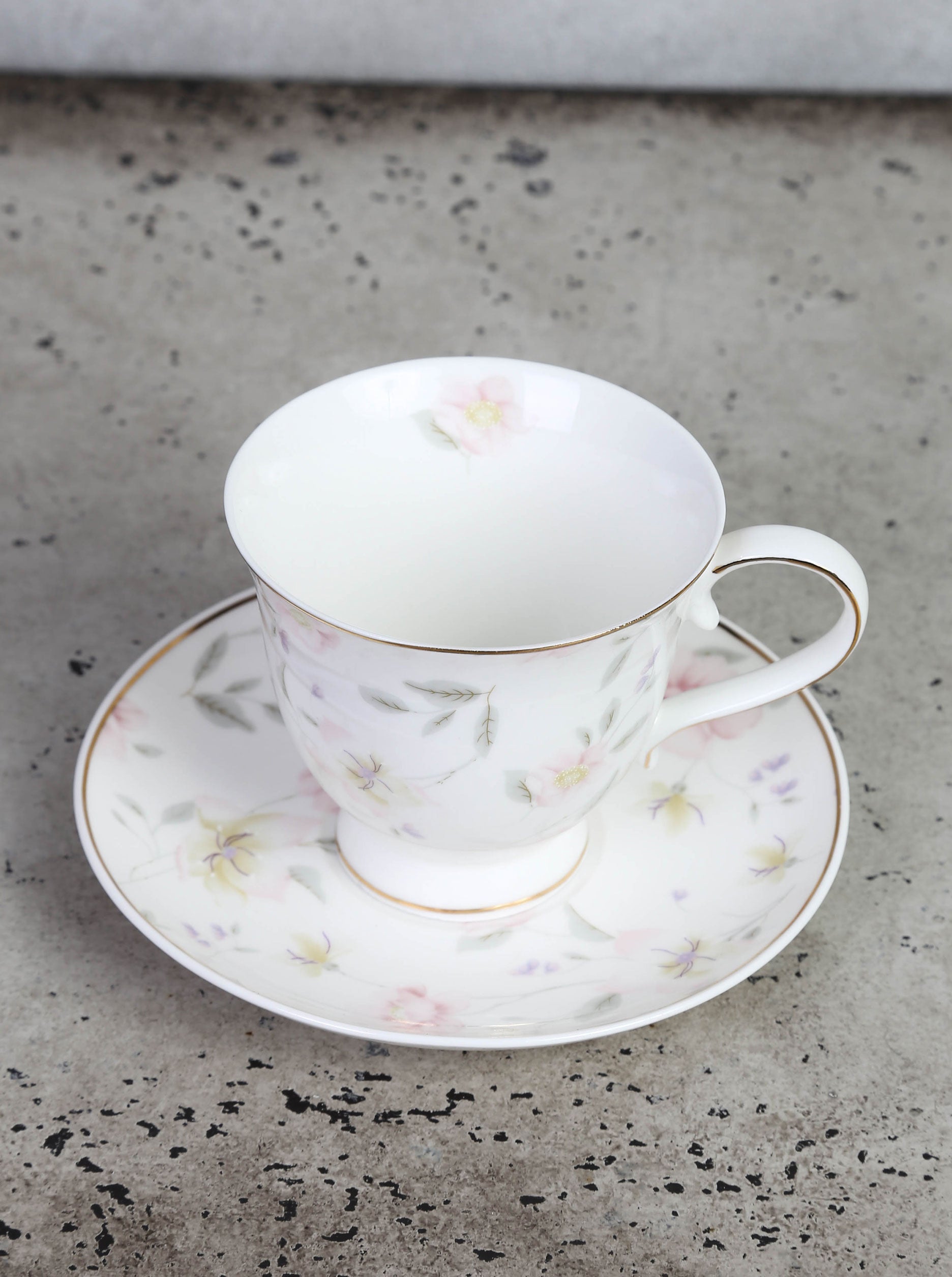 Cup and plate with floral motif and gold edge
