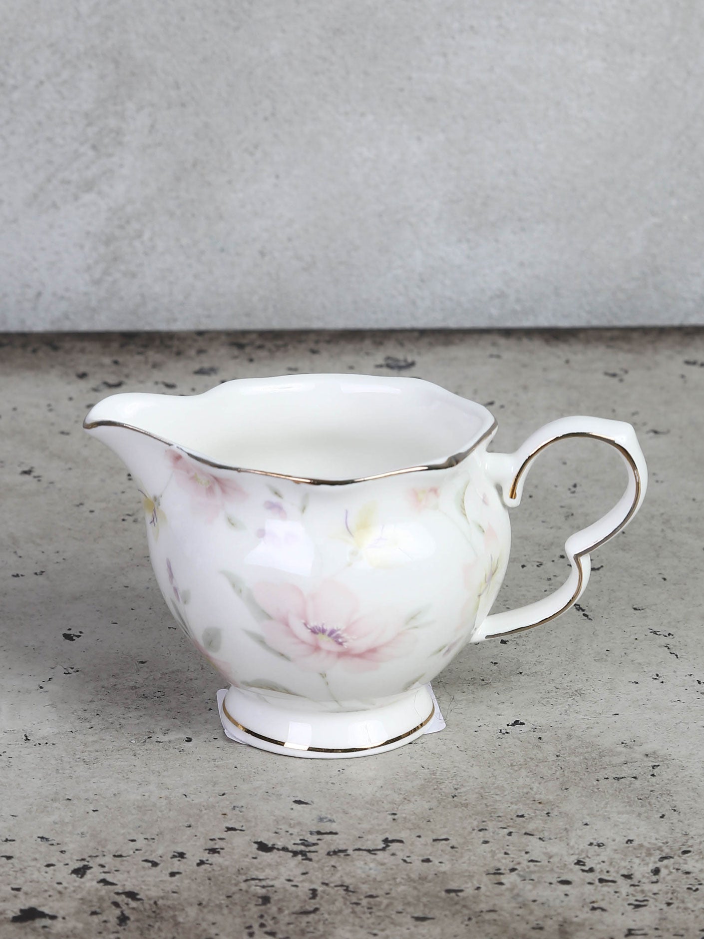 Milk jug or cream jug with floral motif and gold edge