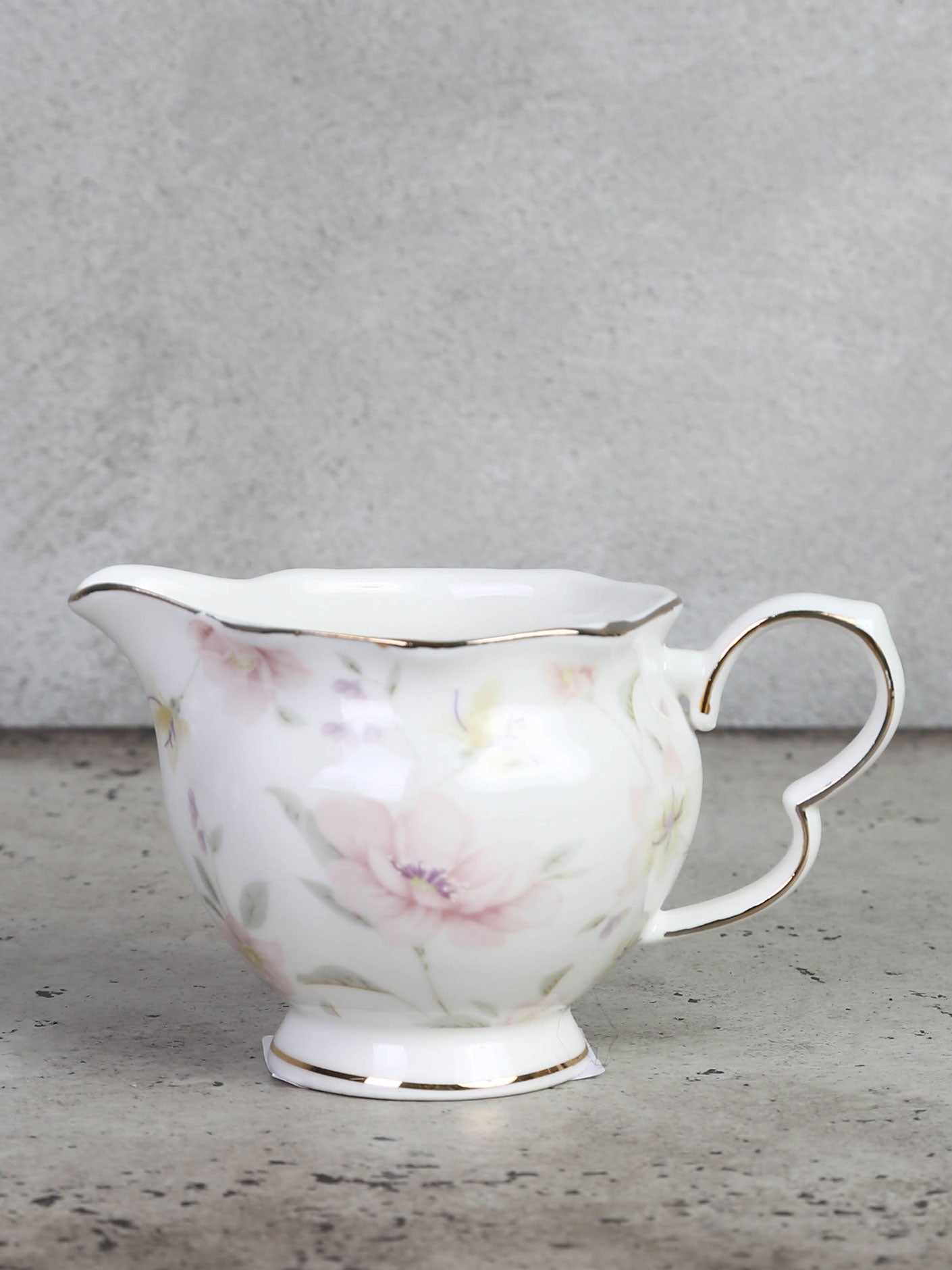 Milk jug or cream jug with floral motif and gold edge