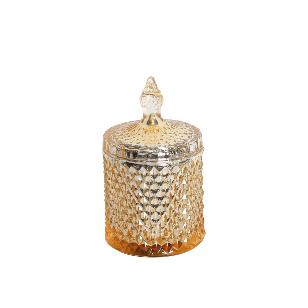 Scented candle in gold jar with lid